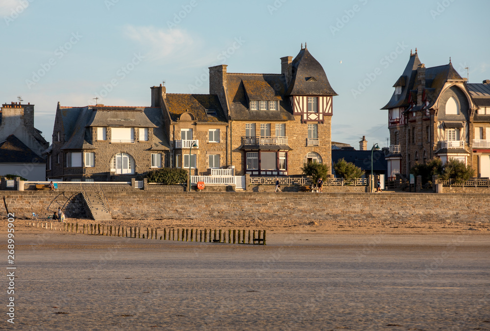 Beach in the evening sun and buildings along the seafront promenade in Saint Malo. Brittany, France Beach in the evening sun and buildings along the seafront promenade in Saint Malo. Brittany, France
