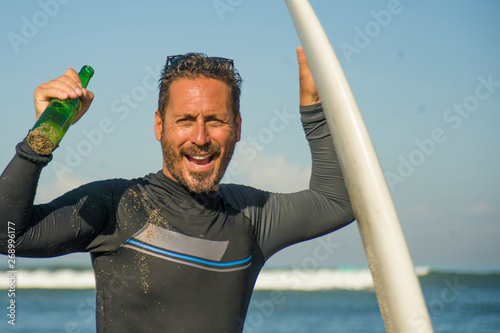 Canvas Print lifestyle portrait of attractive and happy surfer man 3os to 40s in neoprene sur