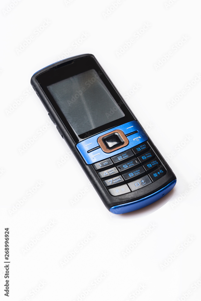 Old mobile phone on white background. Close up. Selective focus. Old mobile phone on white background. Close up. Selective focus.