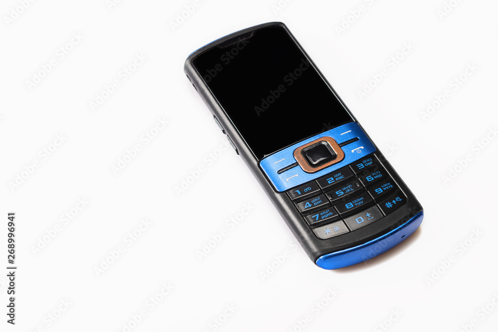 Old mobile phone on white background. Close up. Selective focus. Old mobile phone on white background. Close up. Selective focus.