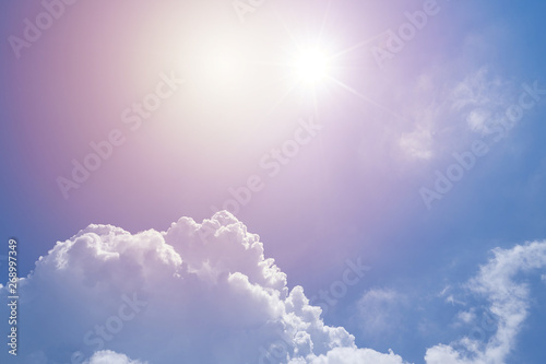 Closeup view of sunlit sky with beautiful cumulus clouds, leak light effect photo