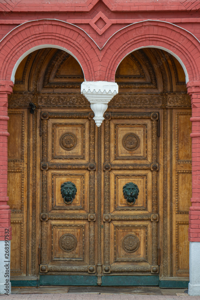 Doors with a carved handle in the form of a lion.
