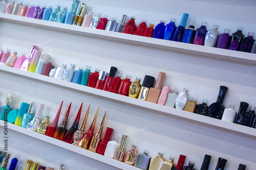 Multicolored bits of perfume on the shop window. Sales