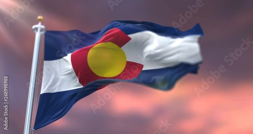 Flag of Colorado state, region of the United States, waving at sunset - loop photo