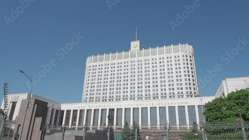 House of the Government of Russian Federation (White House). Russian Government House with flag. Famous state building against clear blue sky. Moscow, Russia.