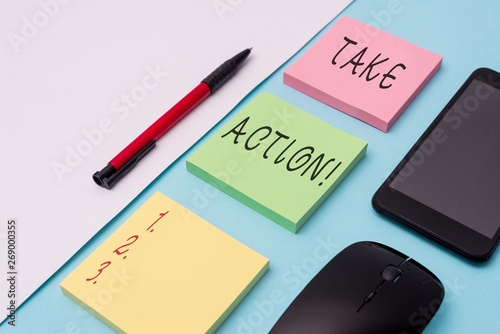 Word writing text Take Action. Business photo showcasing do something official or concerted to achieve aim with problem Note papers and stationary plus gadgets placed sideways above backdrop