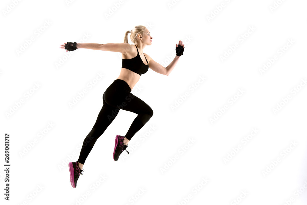 Young athletic girl runs on a white background.