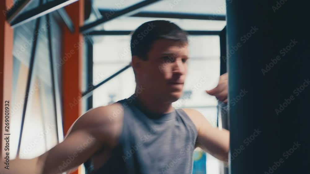 Close-up of a active man practicing his punches gym. Young athlete in gym. Sport concept Close-up of a active man practicing his punches gym. Young athlete in gym. Sport concept