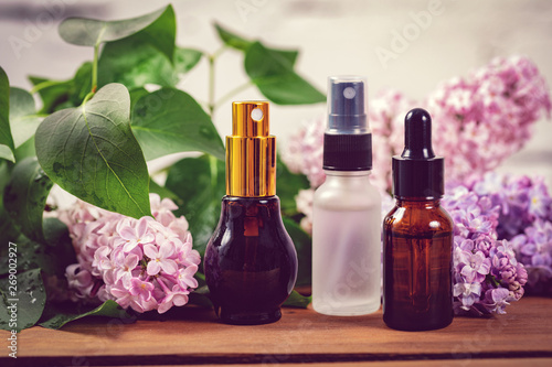 scent sprayers and essential oil bottles with lilac blossoms