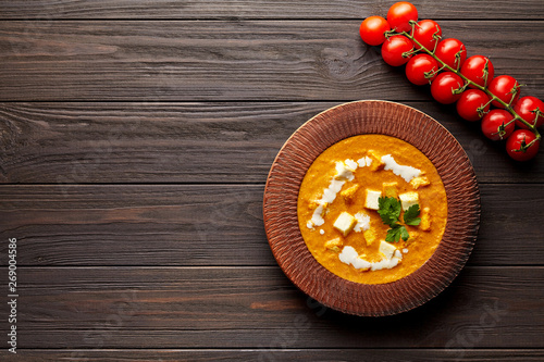 Shahi paneer Indian vegetarian masala gravy Pakistani meal with vegetables and butter paneer cottage cheese spicy food restaurant style north India dish with cherry tomatoes on dark wooden background