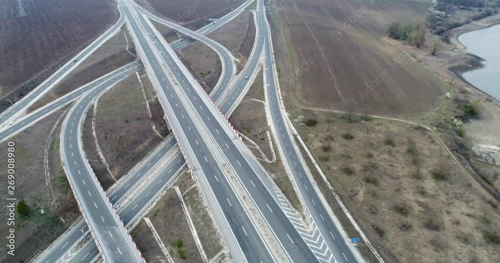 Aerial high drone flight over Highway and overpass. Road junction. Transportation and infrastructure development Aerial high drone flight over Highway and overpass. Road junction. Transportation and infrastructure development