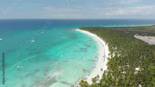 High aerial flight over the tropical island of Saona, Dominican Republic. Beautiful turquoise water and white sandy beach photo