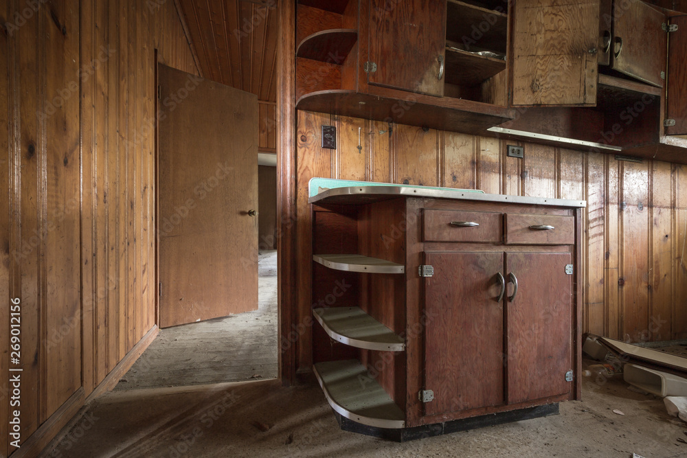 Empty kitchen cabinets left forgotten in an old abandoned home Empty kitchen cabinets left forgotten in an old abandoned home