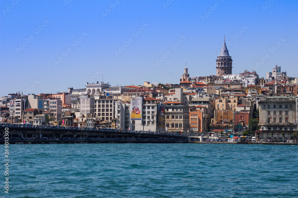 Istanbul, Turkey - June 26, 2017: Turquoise water of the Bosphorus Strait from Istanbul. Bridge over the Bosphon with Galata Tower