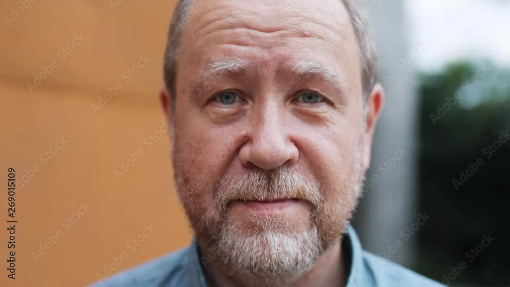 Close-up portrait of handsome serious old man looking straight at camera. Golden age happy grandfather lifestyle. Close-up portrait of handsome serious old man looking straight at camera. Golden age happy grandfather lifestyle.