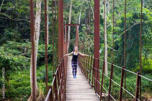 A sporty girl exploring a rainforest. 