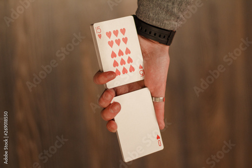 Card trick, a deck of playing cards in a man's hand - the work of a magician