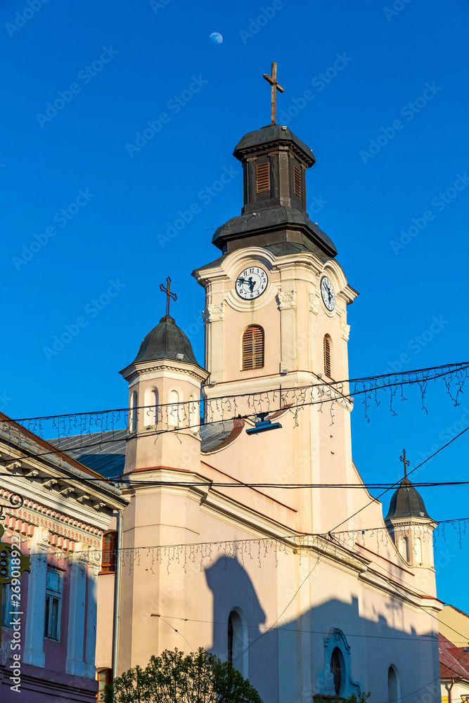 Building of St. George Church in Uzhhorod city, Ukraine. It is a Roman Catholic church built in 1762-1766 in a late Baroque style. City clock placed on the tower