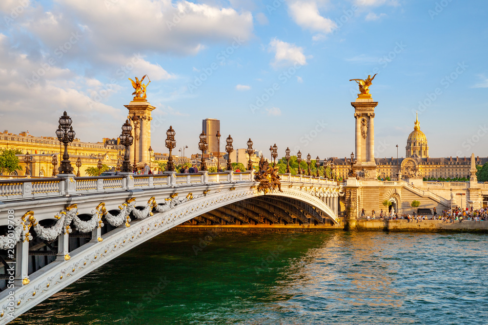 The Alexander III Bridge across Seine river in Paris, France at sunset