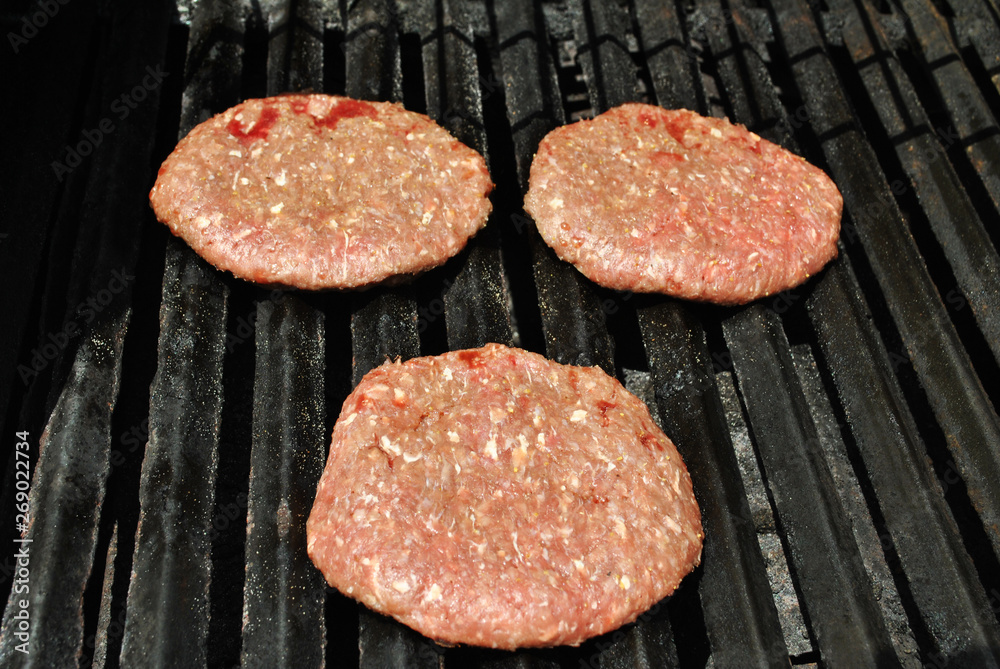 Delicious Summertime Burgers Cooking on a Hot Grill Delicious Summertime Burgers Cooking on a Hot Grill