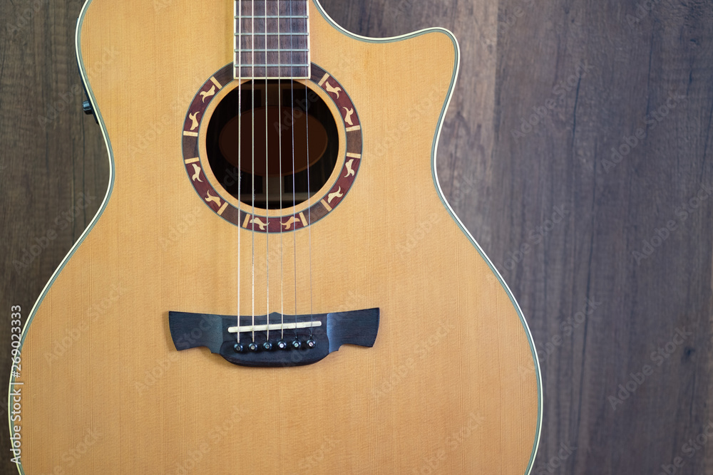 Fototapeta premium Acoustic guitar on wooden background