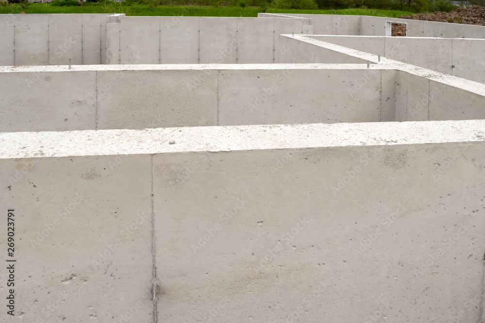 Fototapeta premium New Home House Construction Concrete Cement Foundation Basement Builders