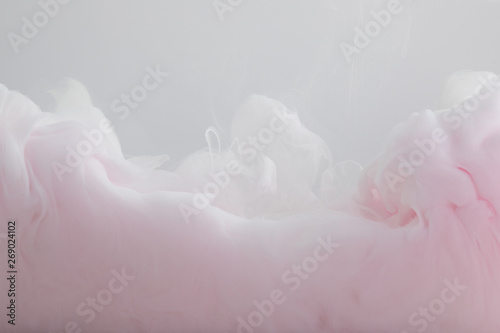 Close up view of light pink paint swirls isolated on grey