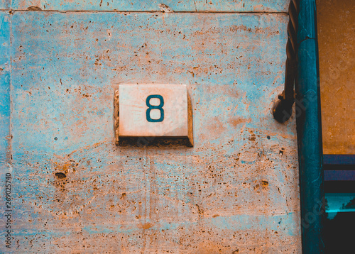 number 8 door sign on orange marble background