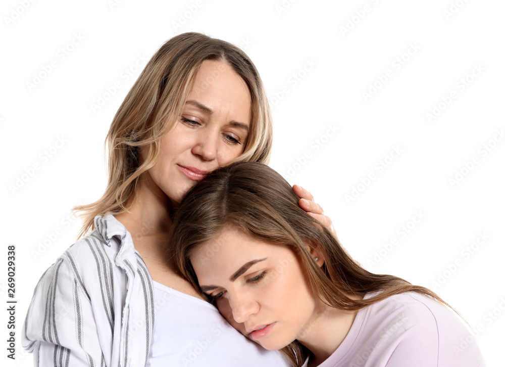 Mother calming her daughter on white background