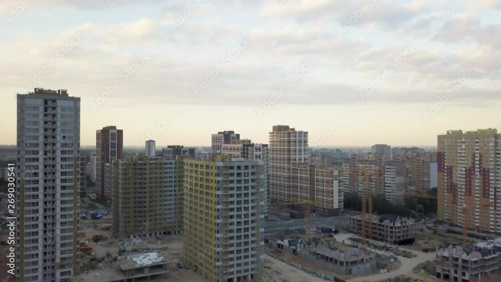 Aerial view of the area with new residential apartments in the evening at sunset. Cityscape. The construction of a lot of apartment buildings reflects urbanization trends Aerial view of the area with new residential apartments in the evening at sunset. Cityscape. The construction of a lot of apartment buildings reflects urbanization trends