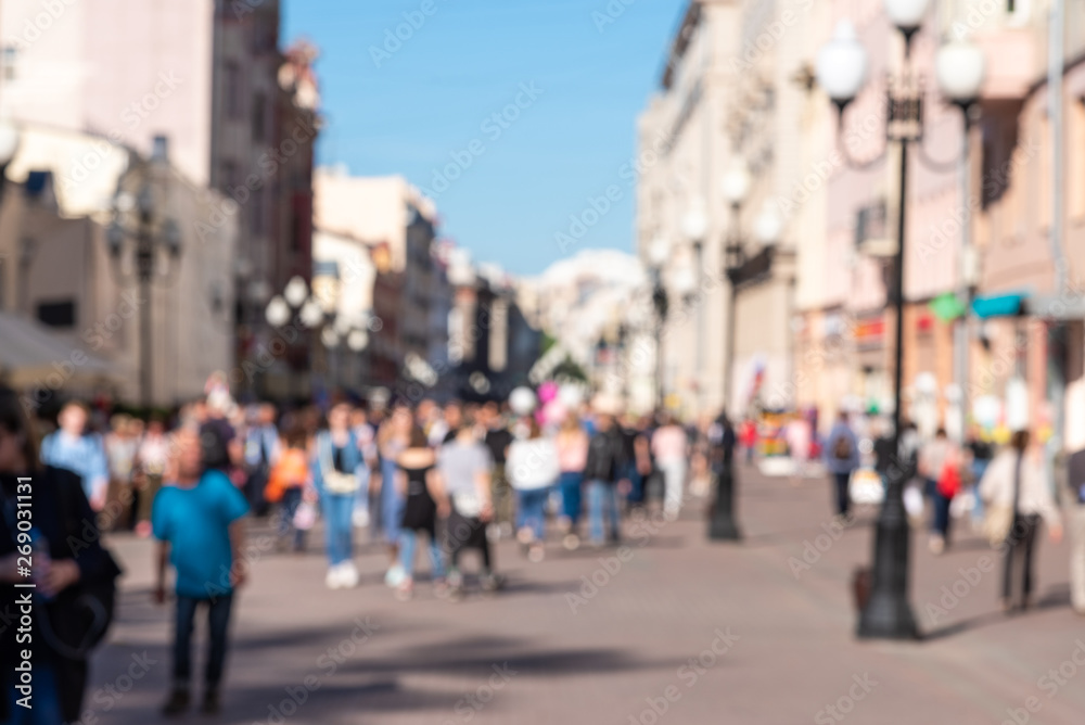 Blurred street of the old town on a sunny day with a crowd of people