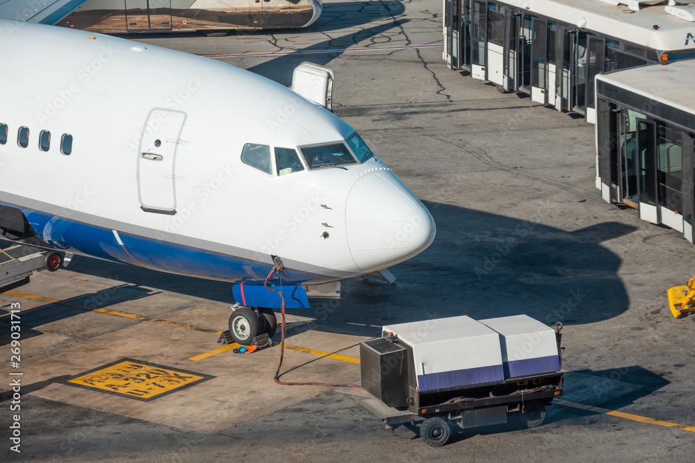 View of nose aircraft, connected to the aircraft after the arrival at the airport of destination. Buses with open doors waiting for passengers from the plane. View of nose aircraft, connected to the aircraft after the arrival at the airport of destination. Buses with open doors waiting for passengers from the plane.