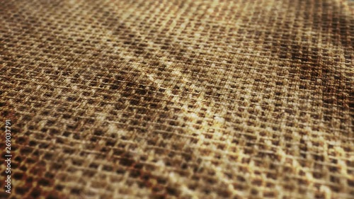 Old, historic sack fabric cloth is waving background. Flax, fiber, beige colored.