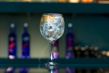 Cristal clear cocktail on bar context with ice cubes inside