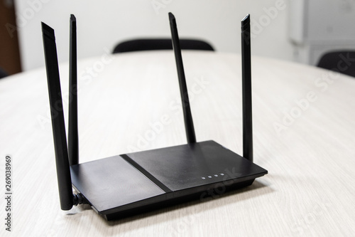 on the table is a dark Wi-Fi router to access the Internet