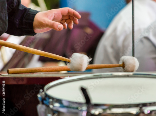 male musician drummer hand withdrum sticks and drum close up