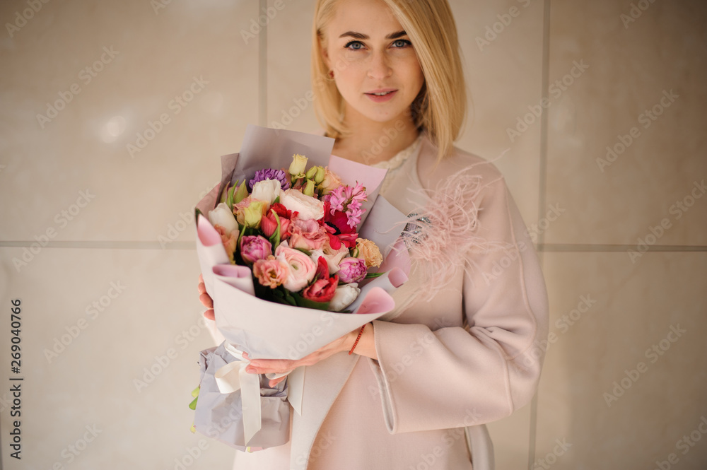 Young girl with bouquet in light blue wrapping Young girl with bouquet in light blue wrapping