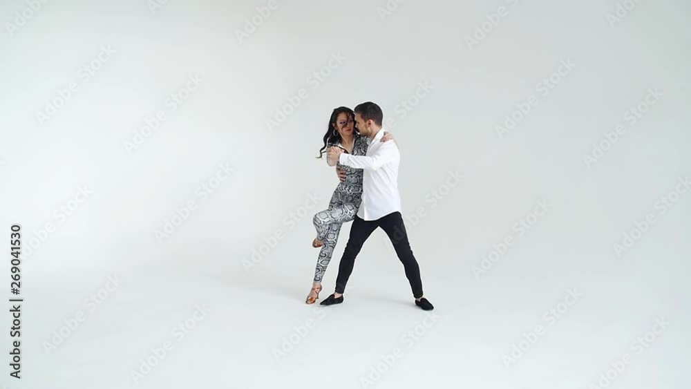 Concept of love, relationships and social dancing. Social dance, salsa, zouk, tango, kizomba concept - beautiful couple dancing bachata Concept of love, relationships and social dancing. Social dance, salsa, zouk, tango, kizomba concept - beautiful couple dancing bachata