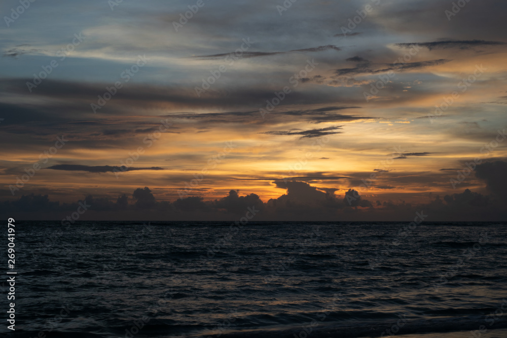 sunset Overcast sky, orange light, calm sea waves