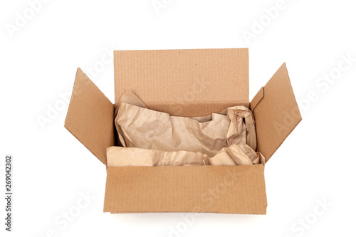 Cardboard box with wrapping paper inside isolated on white background, recycling concept