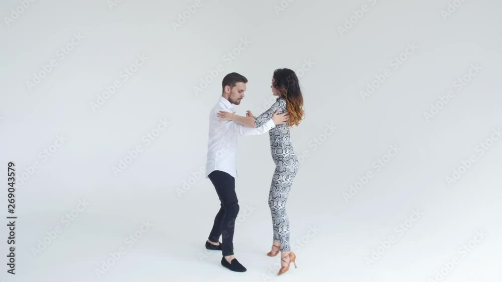 Concept of love, relationships and social dancing. Social dance, salsa, zouk, tango, kizomba concept - beautiful couple dancing bachata