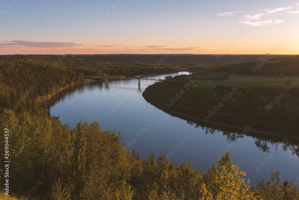 Beautiful sunset over the North Saskatchewan River and Terwillegar Park Footbridge in Edmonton, Alberta, Canada