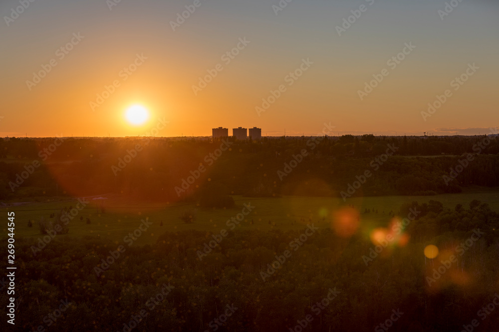 Beautiful sunset, with lens flare, looking towards the River Valley Oleskiw in Edmonton, Alberta, Canada