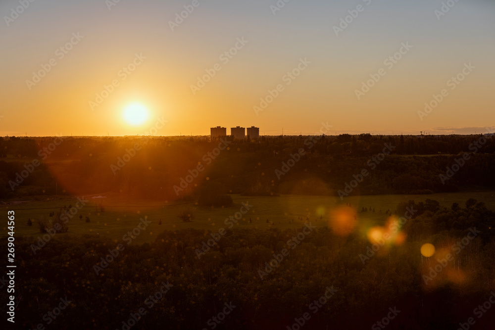Beautiful sunset, with lens flare, looking towards the River Valley Oleskiw in Edmonton, Alberta, Canada