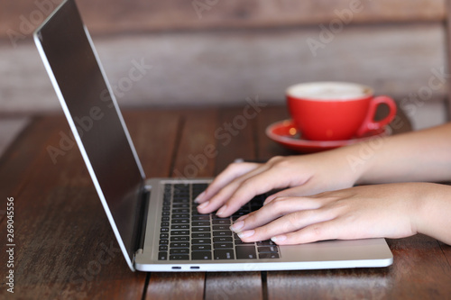 soft focus of young woman of freelancer working using laptop computer in coffee shop, Communication technology and Business concept