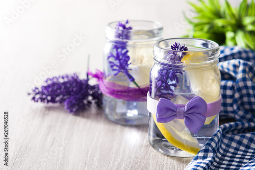 Lavender lemonade drink in jar on white wooden table