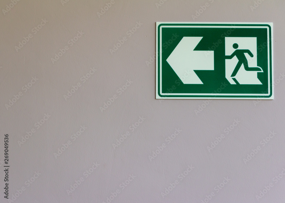 Exit sign on white wall