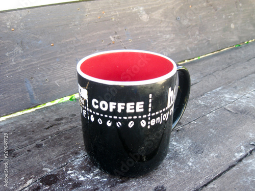 coffee mug on the street against the background of a wooden benchl photo