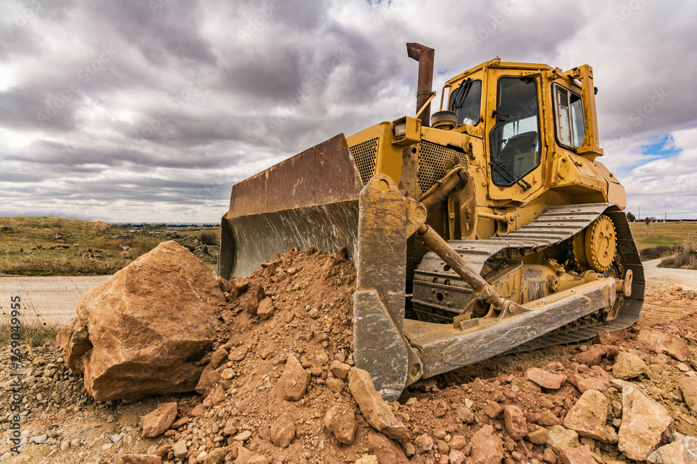 Excavator moving earth on construction works of a highway