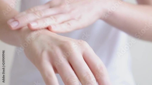 Wallpaper Mural Hands of a young woman applying hand cream, hands massage Torontodigital.ca